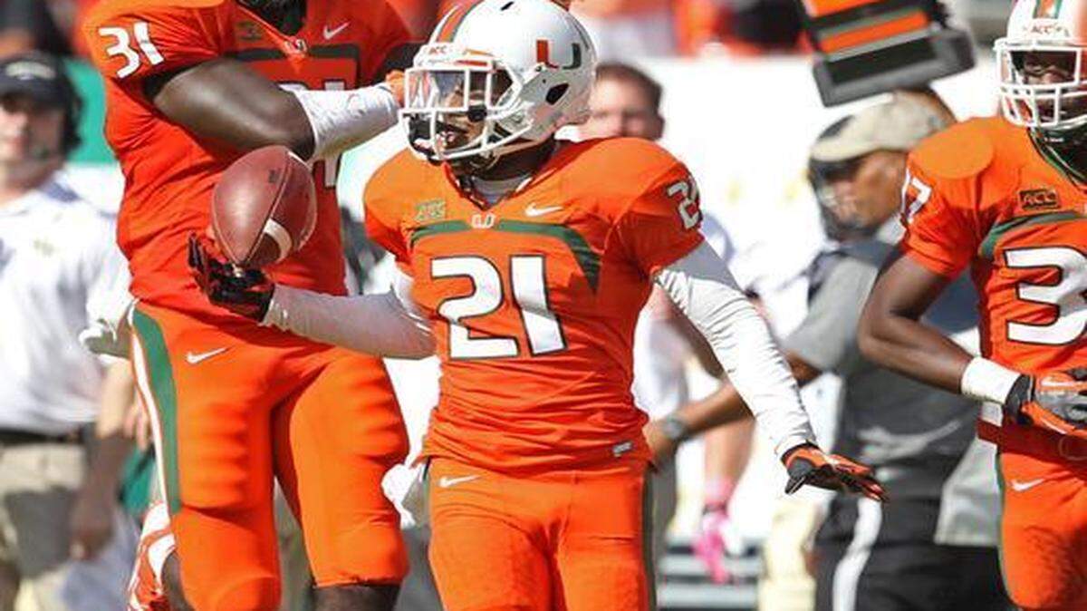 
University of Miami defensive back Antonio Crawford intercepts a pass by Wake Forest quarterback Tanner Price and returns it 5 yards in the final seconds of the fourth quarter of their game at Sun Life Stadium in Miami Gardens on Oct. 26, 2013.
