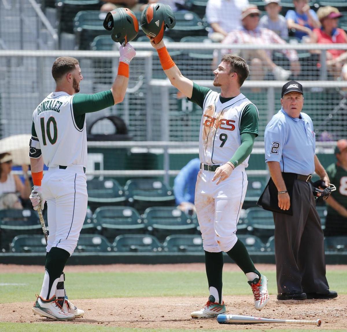 Miami third baseman Romy Gonzalez (10) greets outfielder Carl Chester (9) during a game against Virginia Tech at Mark Light Field on Saturday, May 20, 2017. Chester was drafted by Tampa Bay in June, but infielder Gonzalez returns to the 2018 squad.
