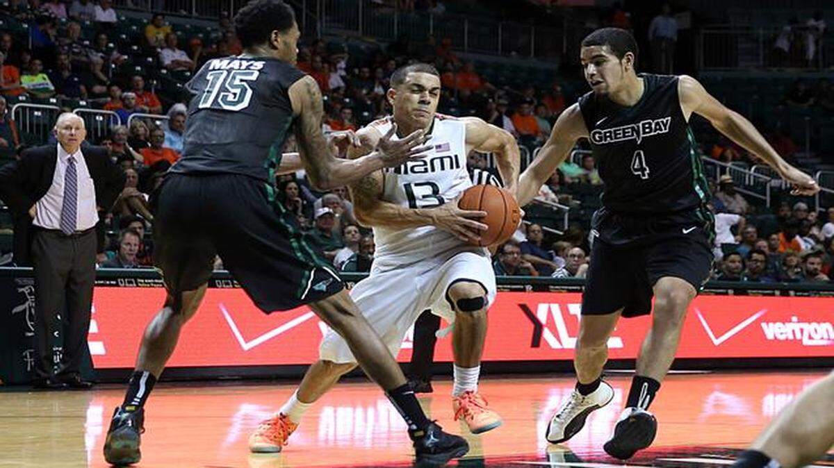 
Angel Rodriguez drives between Greg Mays and Jordan Fouse in the second half of UM’s game against Wisconsin-Green Bay at BankUnited Center in Coral Gables on Saturday, December 6, 2014.
