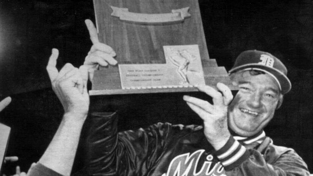 
University of MIami Basball coach Ron Fraser holds the College World Series trophy as team members Eddie Escribano (left) and Phil Lane (right) carry Fraser around the field, following Miami's 9-3 win over Wichita Sate in the NCAA College World Series.
