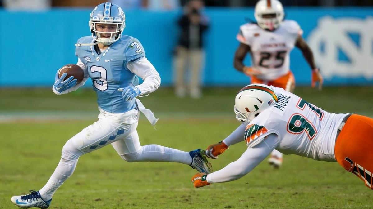 North Carolina's Ryan Switzer evades Miami's Earl Moore during a punt return for a touchdown during the first half of an NCAA college football game, in Chapel Hill, N.C., Saturday, Nov. 14, 2015.