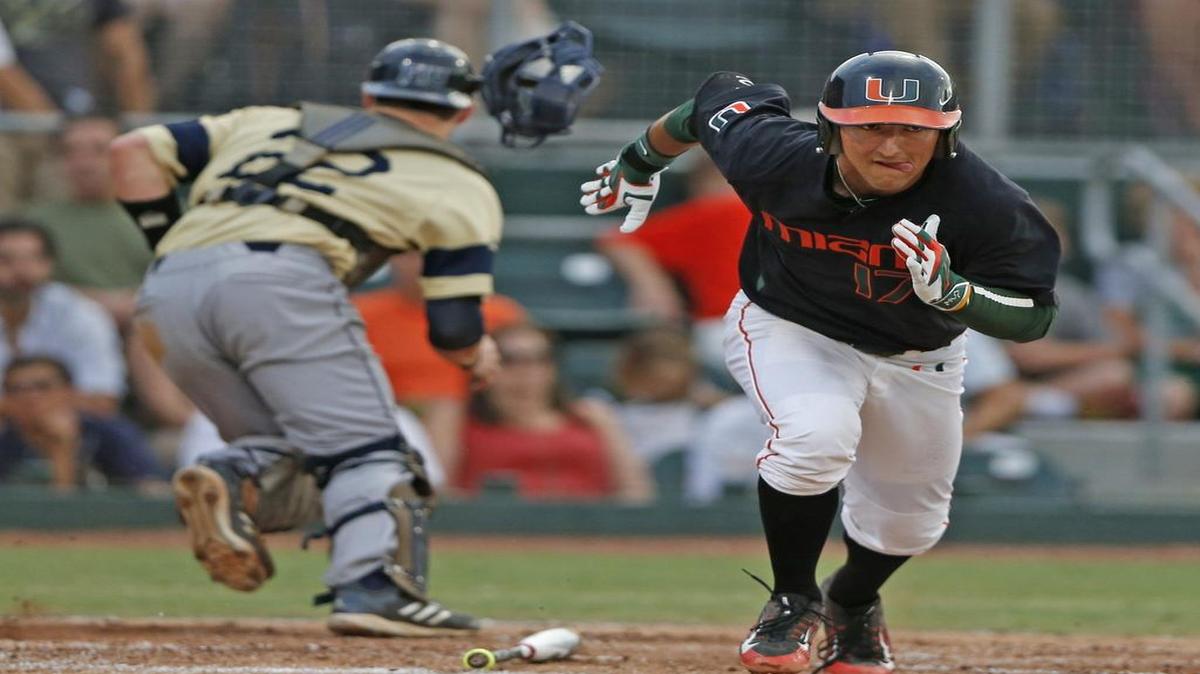 
FIU catcher Zach Soria (22) chases a ball that got by him after a strikeout by Miami first baseman Christopher Barr (17) in the second inning of their the NCAA Tournament game in the Coral Gables Regional at Alex Rodriguez Park at Mark Light Field in Coral Gables on May 29, 2015.

