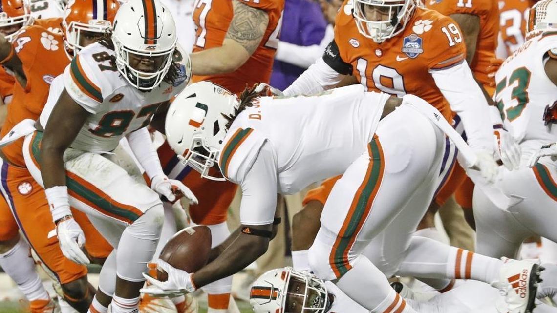 Miami Hurricanes defensive lineman DJ Johnson (1) picks up a Jeff Thomas (4) fumble on a punt return in the third quarter as the University of Miami Hurricanes play Clemson Tigers in the ACC Championship Game at Bank of America Stadium in Charlotte, N.C. on Sat., Dec. 2, 2017.