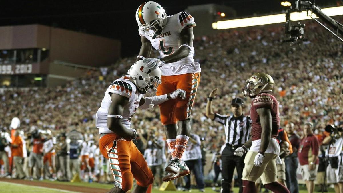 
An injured Miami Hurricanes wide receiver Stacy Coley (3) and wide receiver Herb Waters (6) celebrate Coley's touchdown in the fourth quarter as Florida State University hosts the University of Miami at Doak Campbell Stadium in Tallahassee on Saturday, October 10, 2015.
