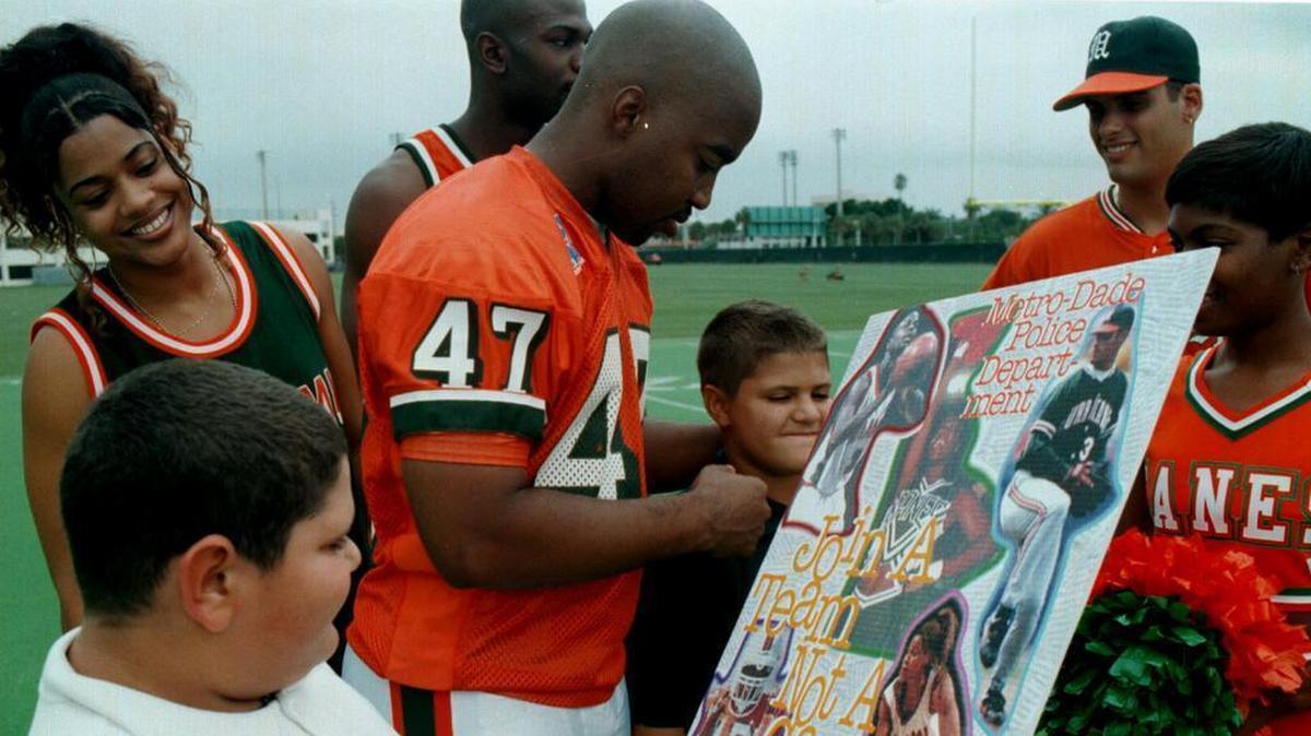 UM linebacker Tony Coley, center, was on hand in 2006 to sign autographs during the kickoff of the ‘Join a Team Not a Gang’ program jointly sponsored by Florida Power and Light, the University of Miami Athletic Deptartment, Boys and Girls Clubs of Miami and Miami-Dade County Public Schools.