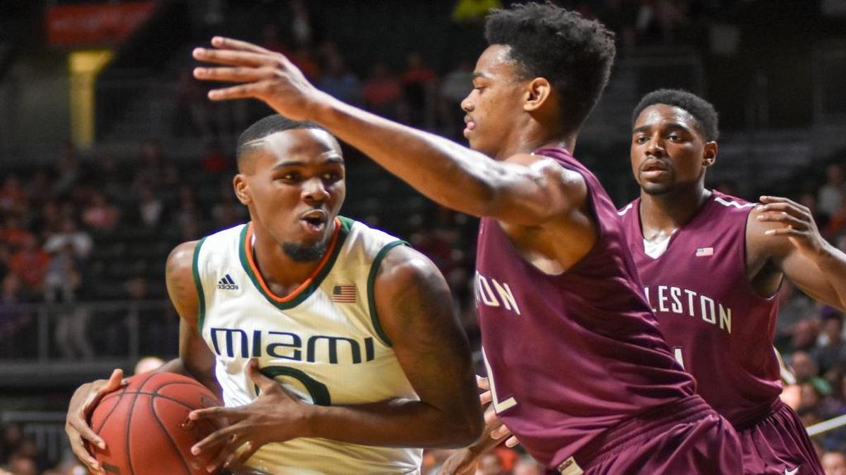 Miami's Ja'Quan Newton attempts to get by Charleston's Cameron Johnson during an NCAA college basketball game in Coral Gables, Fla., Saturday, Dec. 19, 2015.