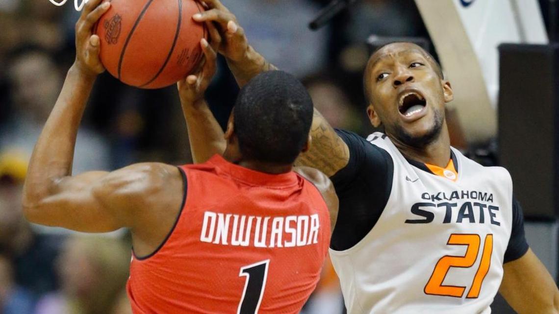 
Oklahoma State forward Kamari Murphy (21) blocks a shot by Texas Tech guard Randy Onwuasor (1) in the Big 12 men's tournament in Kansas City, Mo., Wednesday, March 12, 2014. 
