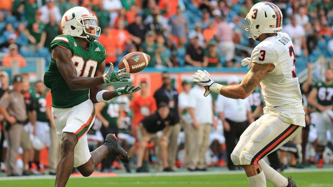 Miami Hurricanes wide receiver Dayall Harris (80) on a second quarter pass reception for a touchdown as Virginia Cavaliers safety Quin Blanding (3) defends at Hard Rock Stadium on Saturday, November 18, 2017. UM announced on Tuesday, June 5, that Harris is leaving the program after he gets his degree.