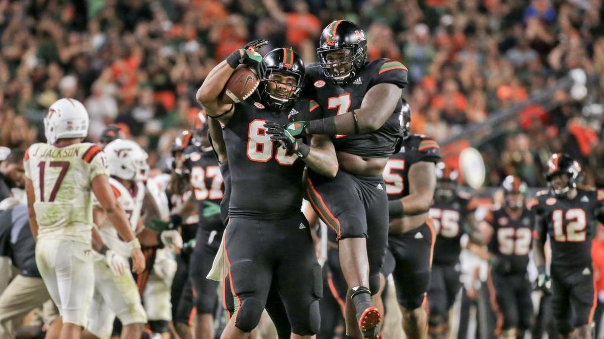 Miami Hurricanes defensive tackles RJ McIntosh (80) and Kendrick Norton (7) celebrate after McIntosh recovers a fumble for a turnover in the second quarter as the University of Miami hosts Virginia Tech Hokies at Hard Rock Stadium on Saturday, November 4, 2017.