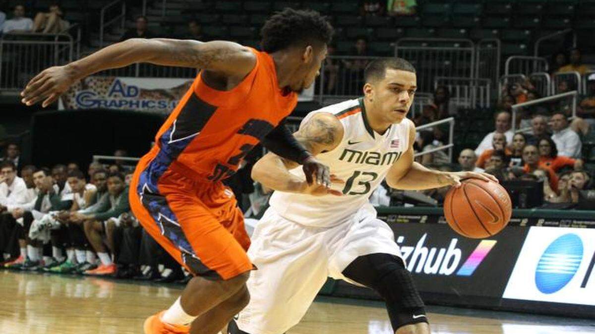 
Angel Rodriguez drives against Khalen Pinkett in the first half of UM's game against Savannah State at BankUnited Center in Coral Gables on Monday, Dec. 8, 2014.
