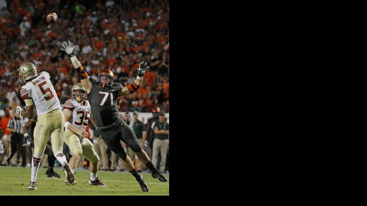 
UM defensive end Anthony Chickillo attempts to block a pass by FSU quarterback Jameis Winston at SunLife Stadium on Saturday, Nov. 15, 2014.
