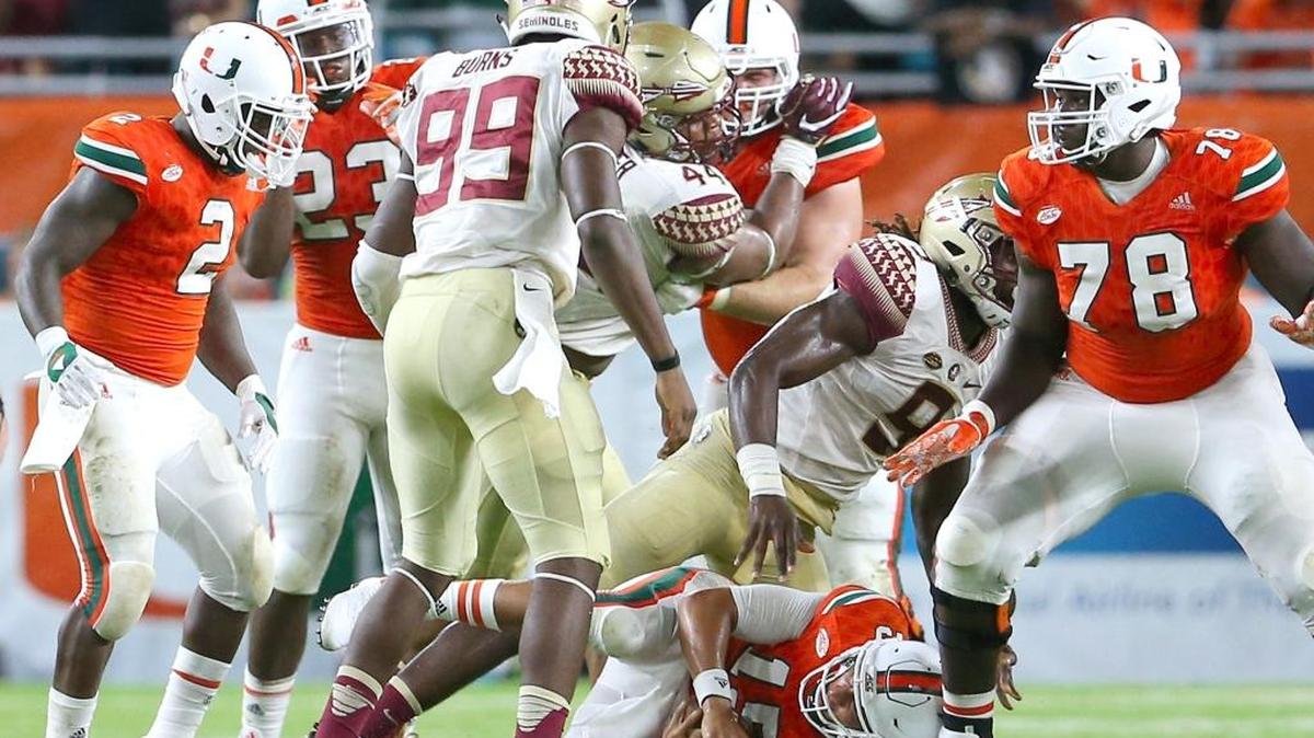 University of Miami Hurricanes quarterback Brad Kaaya,15, is sacked by Florida State Seminoles defensive end Josh Sweat, 9, in the fourth quarter of an NCAA college football game at Hard Rock Stadium on Sat., Oct. 8, 2016, in Miami Gardens.