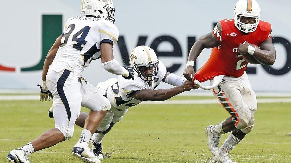 UM tailback Joe Yearby gains yardage against Georgia Tech at Sun Life Stadium in Miami on Saturday, Nov. 21, 2015. Miami won 38-21.