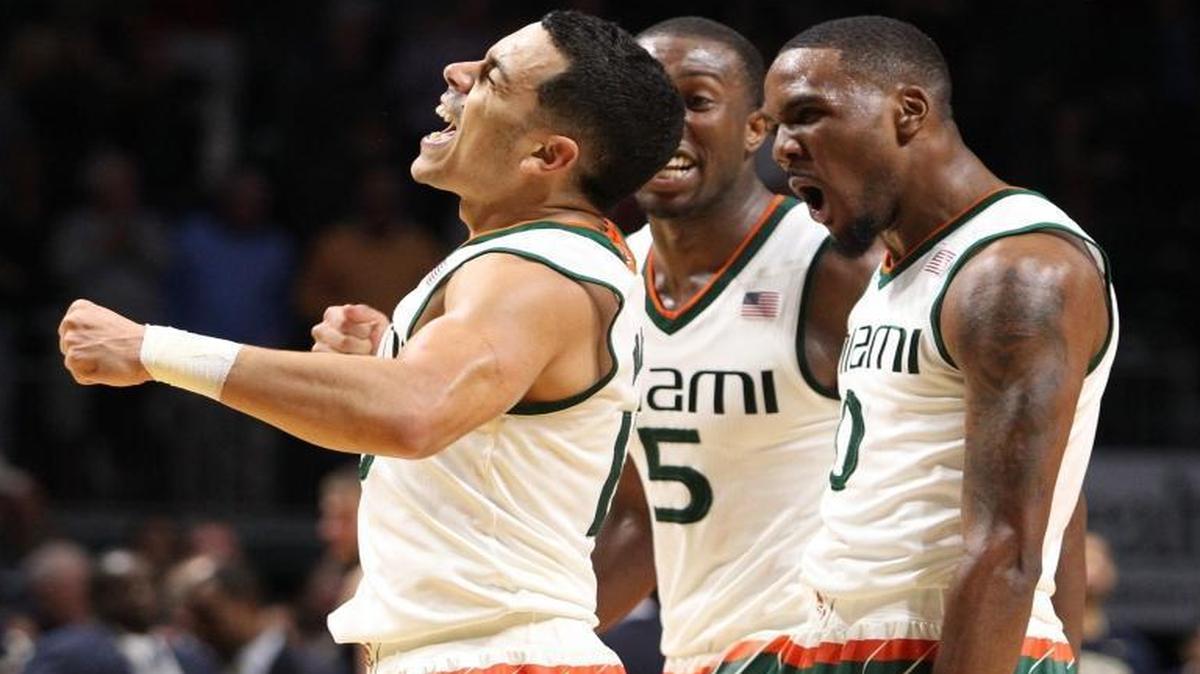 Angel Rodriguez of the Miami Hurricanes celebrates with Davon Reed, center, and Ja’Quan Newton after scoring the winning shot with 1.4 seconds left against Pittsburgh Panthers at BankUnited Center in Coral Gables on Tuesday, Febraury 9, 2016.