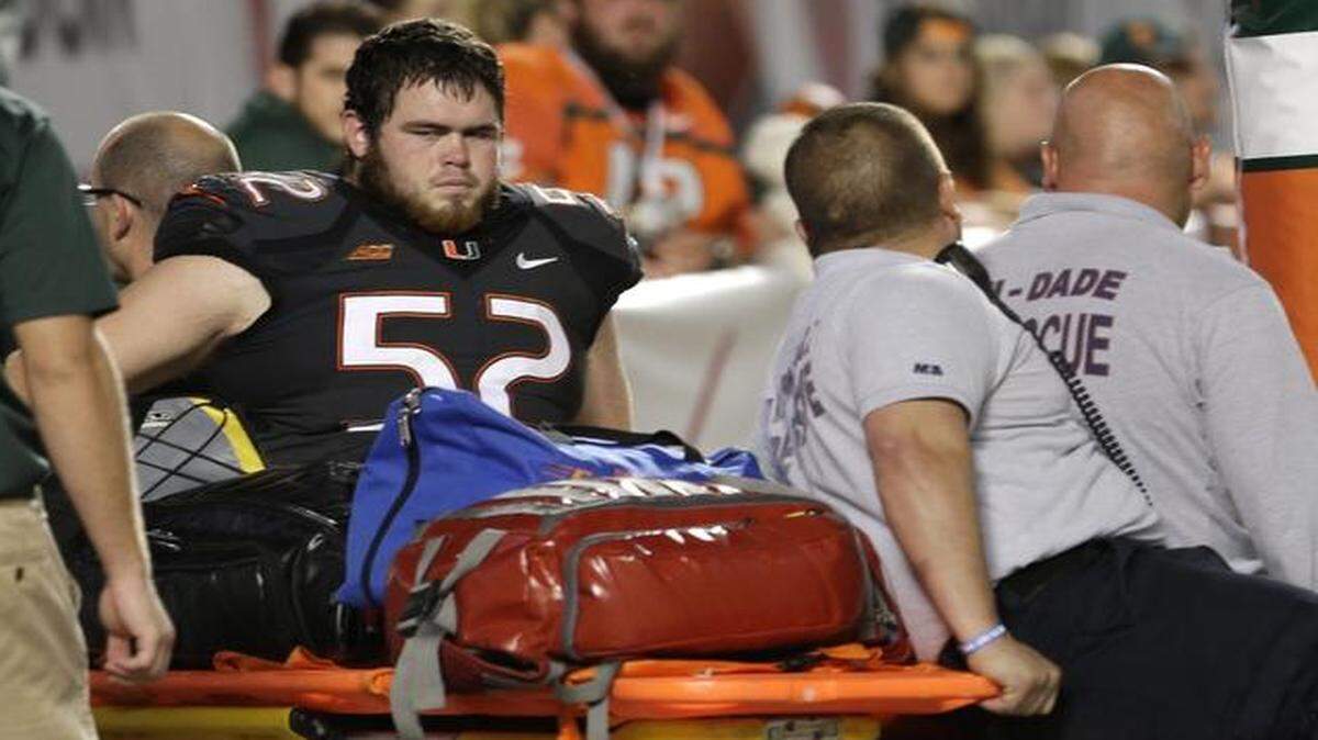 
Miami offensive linesman Kc McDermott (52) is taken off the field after sustaining an injury against Duke in Miami Gardens, Fla., Saturday, Sept. 27, 2014. 
