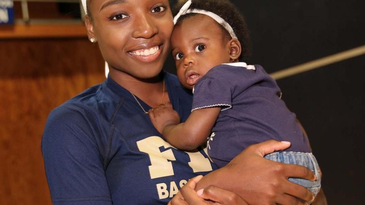 FIU basketball star Kiandre'a Pound holds her daughter Kynsley at FIU Arena on Nov. 9, 2016. Kiandre'a took time off from the game to have a baby.
