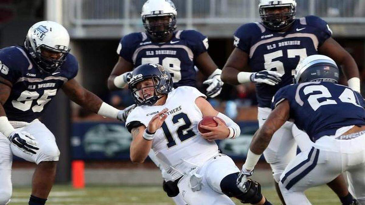 
FIU's Alex McGough is caught for a loss at by ODU at S.B. Ballard Stadium in Norfolk on Saturday, Nov. 8, 2014. 

