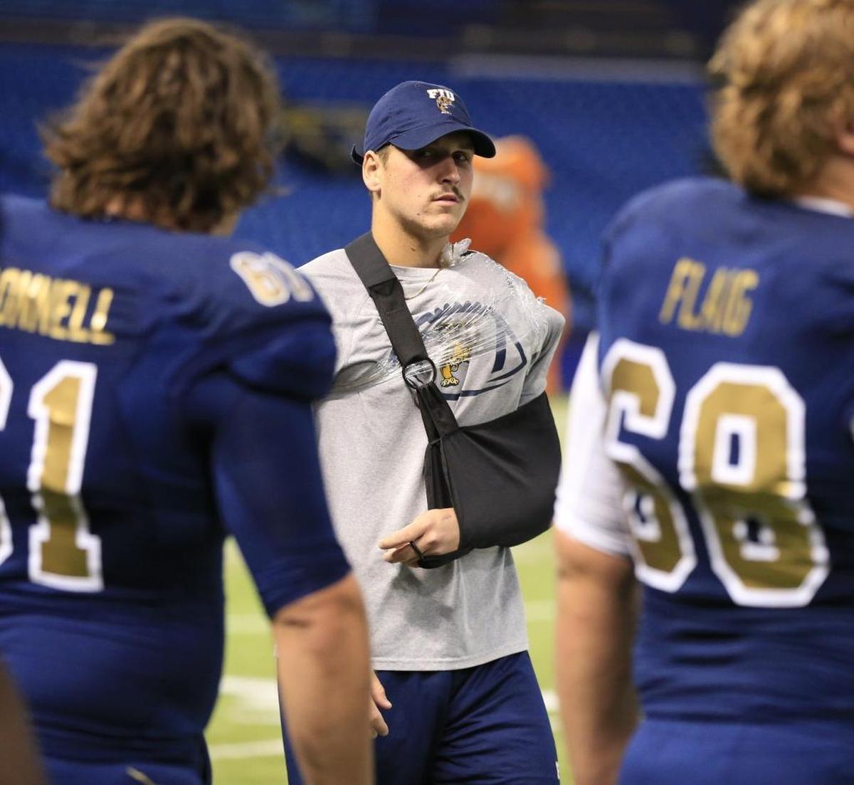 FIU Golden Panthers quarterback Alex McGough (12) in a sling after being injured in the first quarter during the Bad Boy Mowers Gasparilla Bowl at Tropicana Field in St. Petersburg, Fla., on Thursday, Dec. 21, 2017.