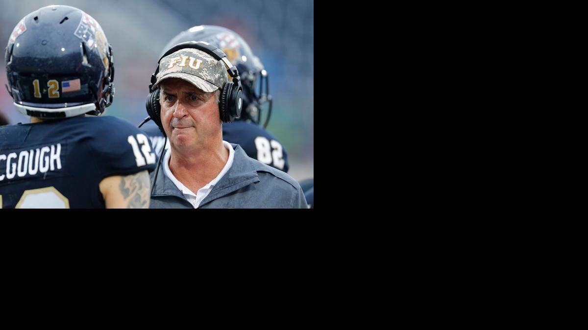 
Head coach Ron Turner talks to Alex McGough # 12 of the Florida International Panthers after he threw an interception against the Louisville Cardinals on September 20, 2014 at FIU Stadium in Miami, Florida.
