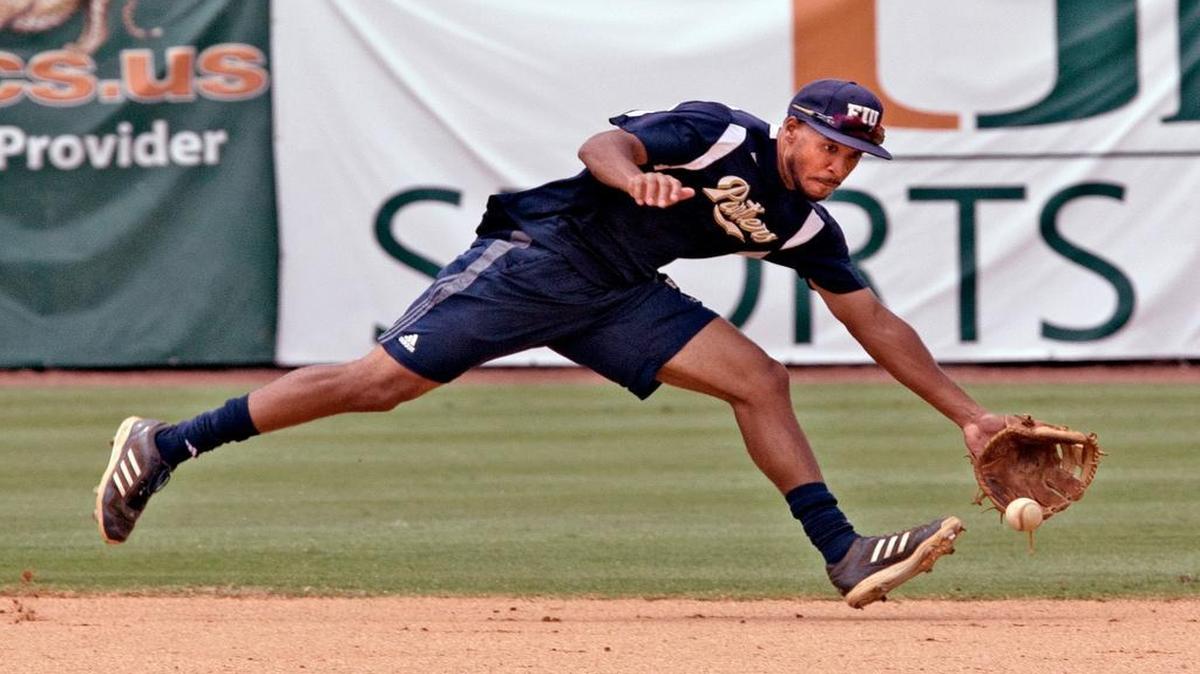 
FIU shortstop Julius Gaines reaches for a ground ball during fielding practice on Thursday at Mark Light Field, where the surging Panthers will face the University of Miami in the Coral Gables Regional on Friday.
