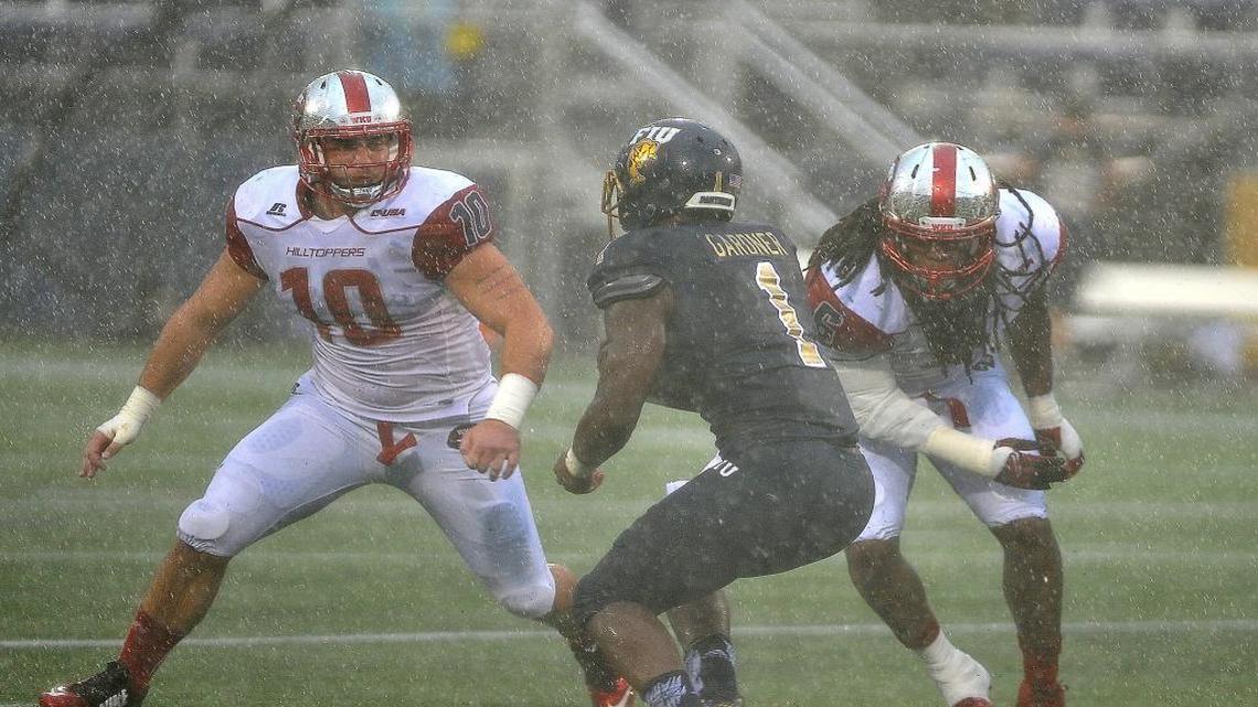 Florida International University running back Alex Gardner (1) tries to evade WKU linebackers Nick Holt (10) and T.J. McCollum as he carries the ball during a college football game Saturday Nov. 21, 2015 in Miami against Western Kentucky University. WKU beat FIU 63-7