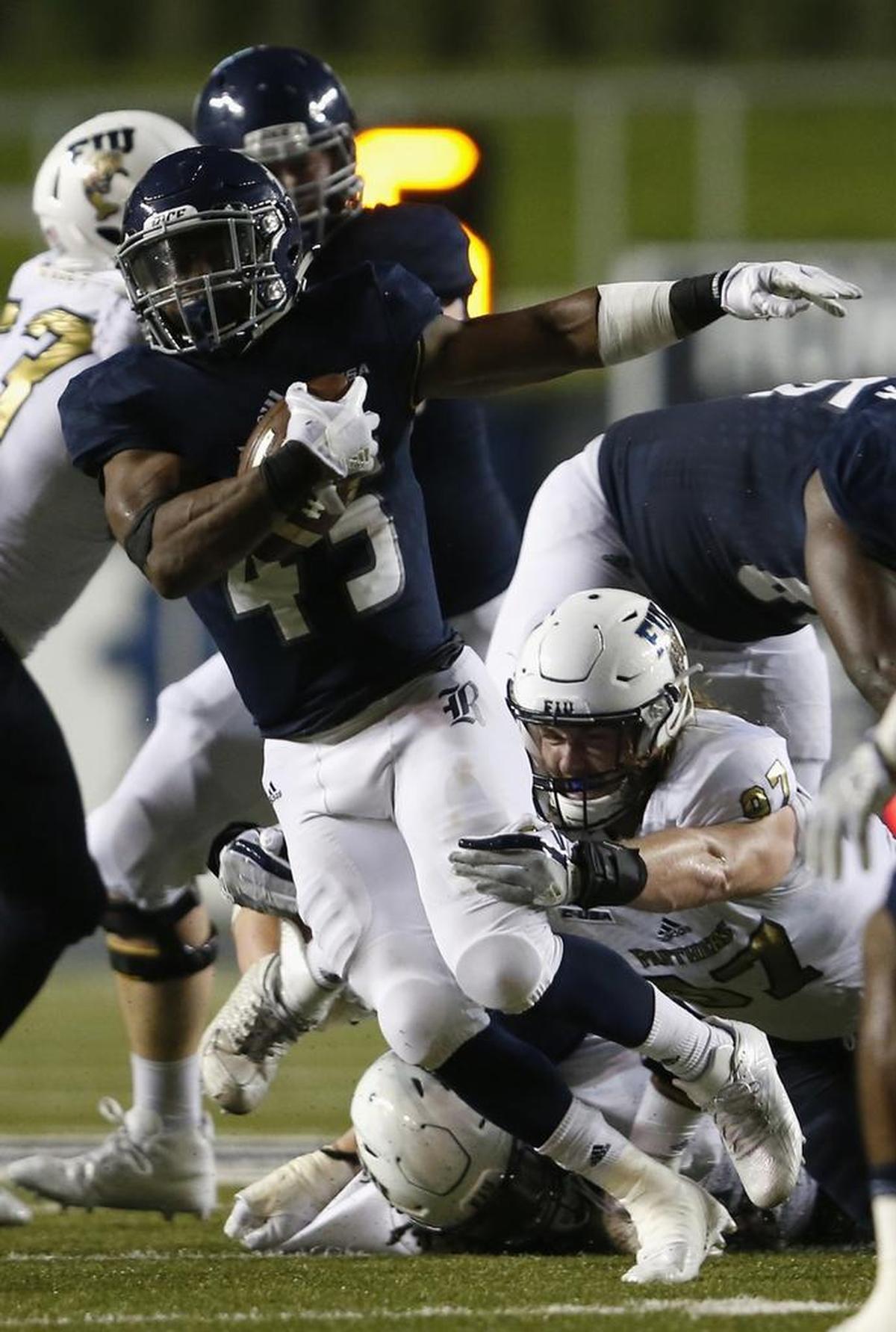 Samuel Stewart #45 of the Rice Owls is tackled by Newton Salisbury #97 of the FIU Golden Panthers in the fourth quarter at Rice Stadium on Sept. 23, 2017 in Houston, Texas.