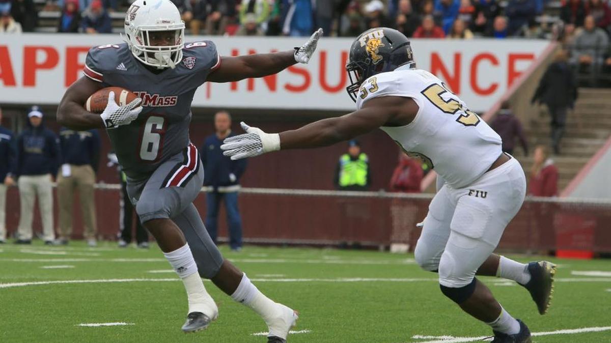 
Massachusetts’ Jamal Wilson (6) carries as FIU’s Anthony Wint (53) closes in Saturday, Oct. 3, 2015 in Amherst, Mass.
