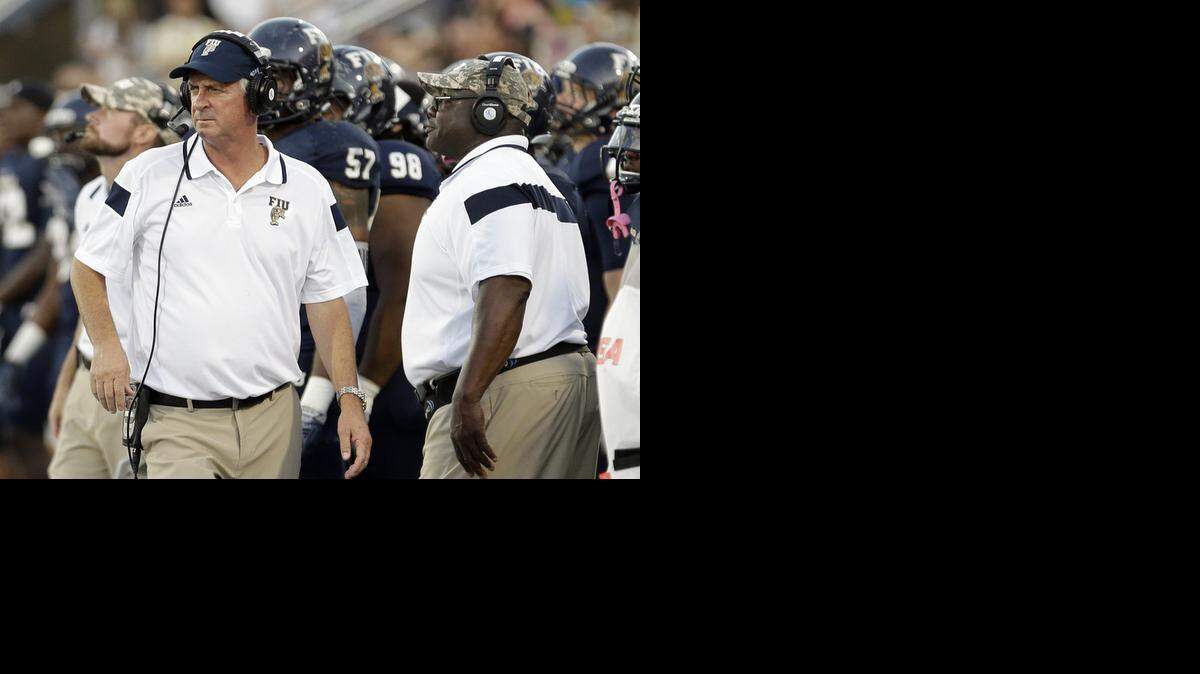 
FIU coach Ron Turner, left, walks on the sideline during a game against Marshall , Saturday, Oct. 18, 2014, in Miami.
