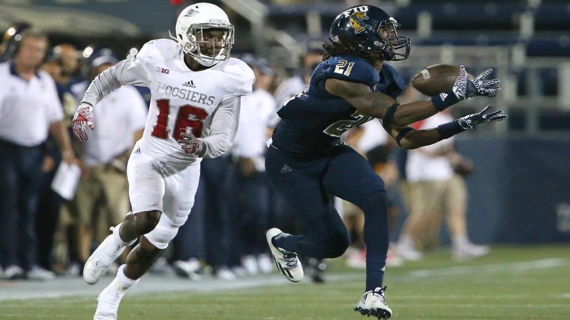 Explosive FIU freshman wide receiver Stantley Thomas, right, catches a pass against Austin King of Indiana in the third quarter of Thursday’s season-opening game at FIU Stadium.