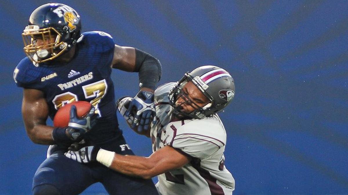 
FIU tight end Jonnu Smith breaks a tackle to score against N.C. Central on Saturday, Sept. 19, 2015 at FIU.
