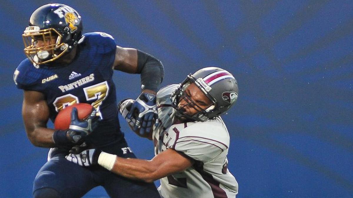 FIU tide end Jonnu Smith breaks a tackle to score a touchdown against the N.C. Central Eagles on Saturday.
