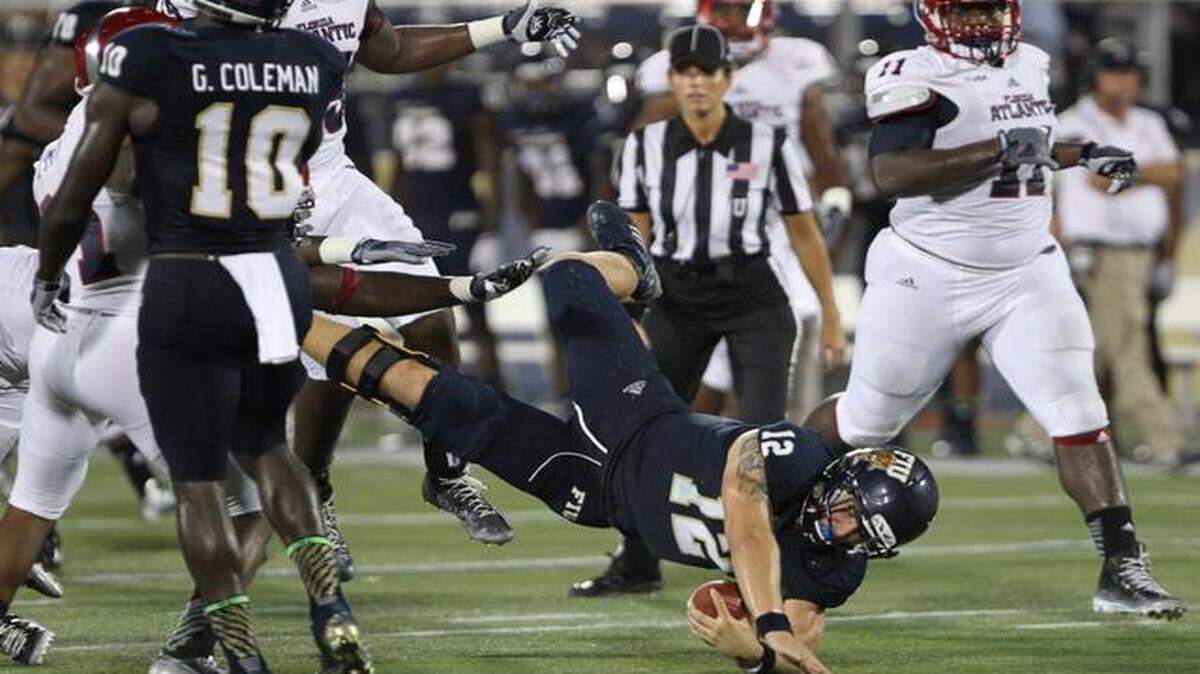 
Alex McGough, quarterback for FIU, scrambles for a gain of 13 yards in the second quarter as the FIU Panthers play the FAU Owls on Ocean Bank Field at Florida International University Stadium in Miami.
