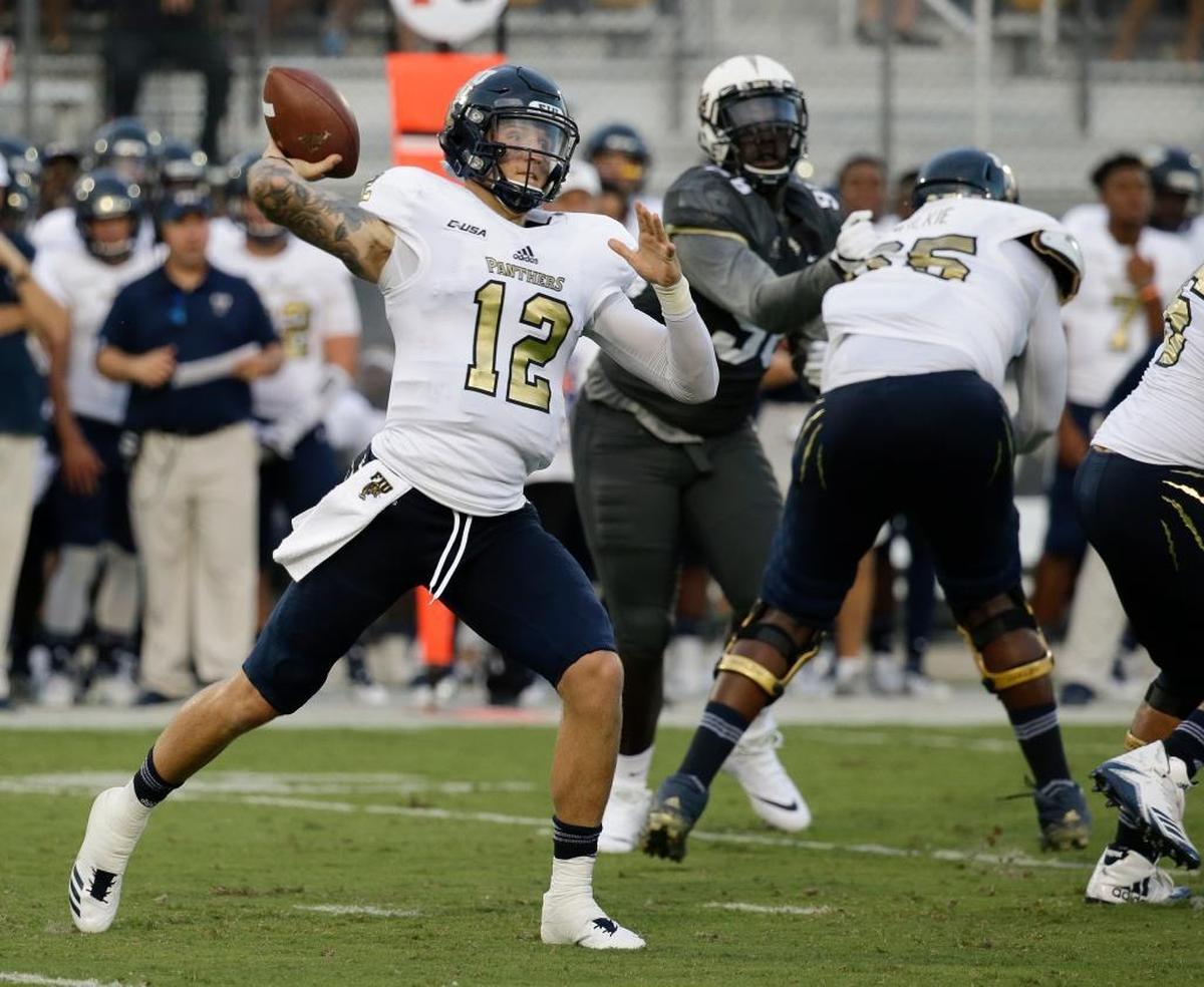 Florida International quarterback Alex McGough (12) throws a pass against Central Florida during the first half of an NCAA college football game, Thurs., Aug. 31, 2017, in Orlando, Fla.