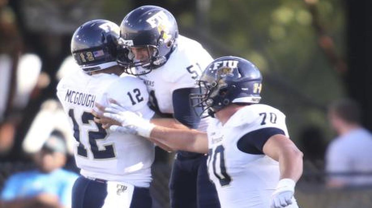 
Florida International quarterback Alex McGough (12), offensive lineman Brandon Taylor (51) and offensive tackle Aaron Neilson (70) celebrate after McGough threw a touchdown pass in the first half of an NCAA college football game against UAB, Saturday, Sept. 27, 2014, in Birmingham, Ala. 

