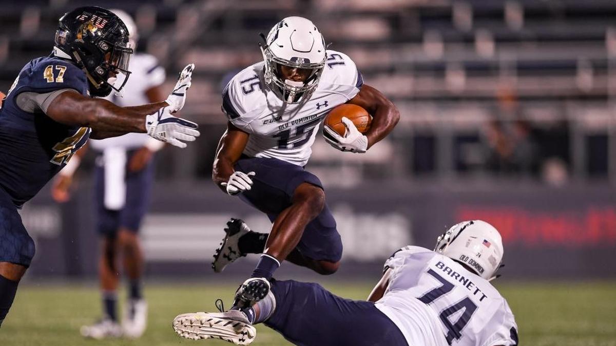 Old Dominion wide receiver Isaiah Harper (15) leaps over offensive lineman Tony Barnett (74) during the first half of the game against the FIU Panthers at Riccardo Silva Stadium on Nov. 11, 2017 in Miami.