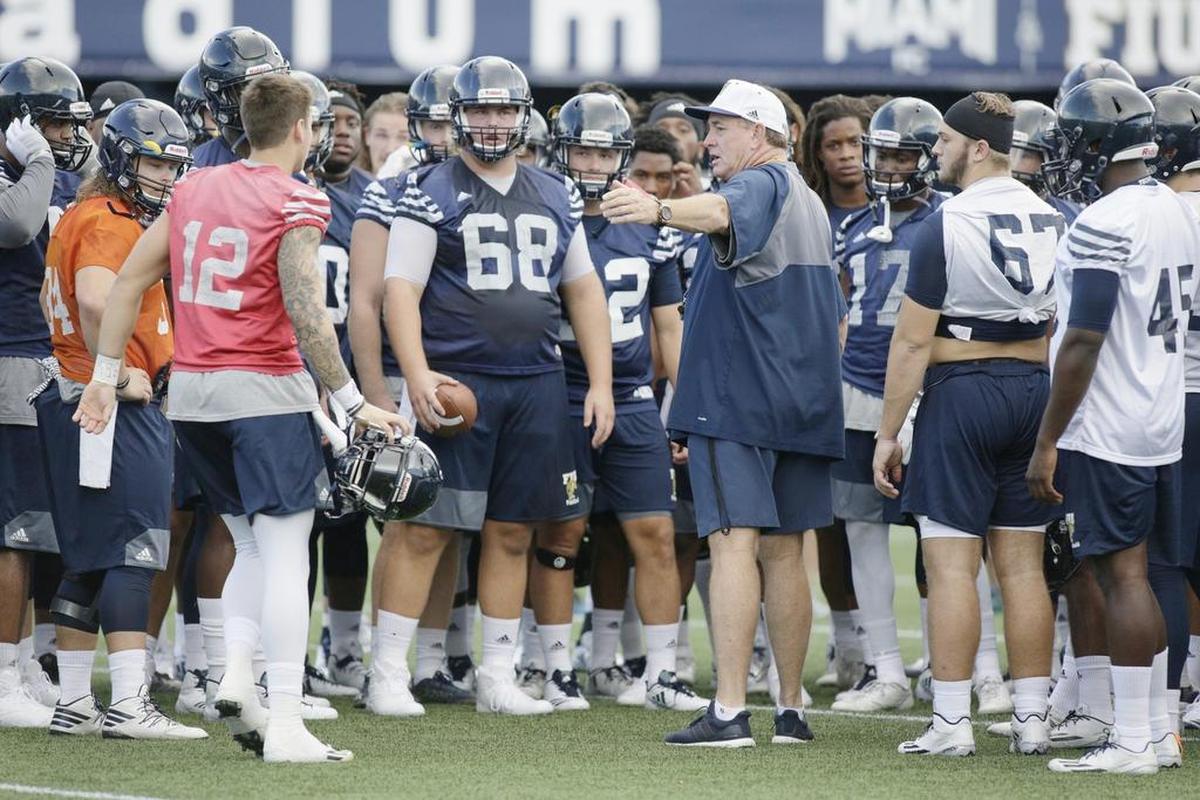 FIU coach Butch Davis talks with his players during the team’s first practice at Riccardo Silva Stadium in July. Davis, 65, is back in coaching after a hiatus during which he was a TV analyst.