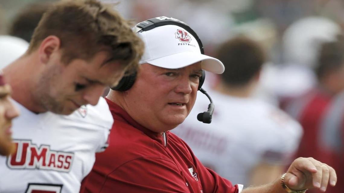 
Massachusetts head coach Mark Whipple, right, talks to quarterback Blake Frohnapfel during the first half against Notre Dame, Saturday, Sept. 26, 2015, in South Bend, Ind. 
