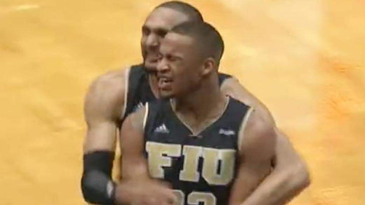 
FIU guard Dennis Mavin is hugged by teammate Adrian Diaz after sinking a halfcourt shot at the buzzer to defeat Texas-San Antonio 57-54 in the Conference USA tournament in Birmingham, Ala., on Wednesday, March 11, 2015.
