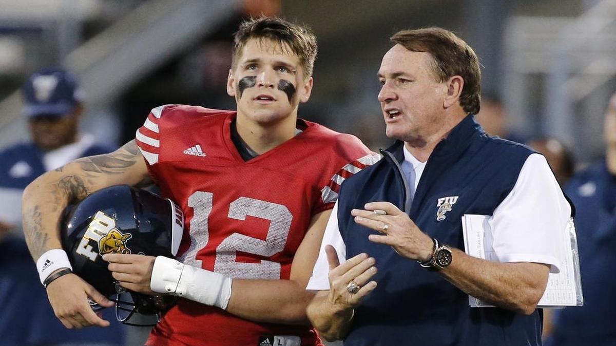 FIU coach Butch Davis talks to quarterback Alex McGough during the Panthers spring football game at FIU Stadium on Friday, April 7, 2017.