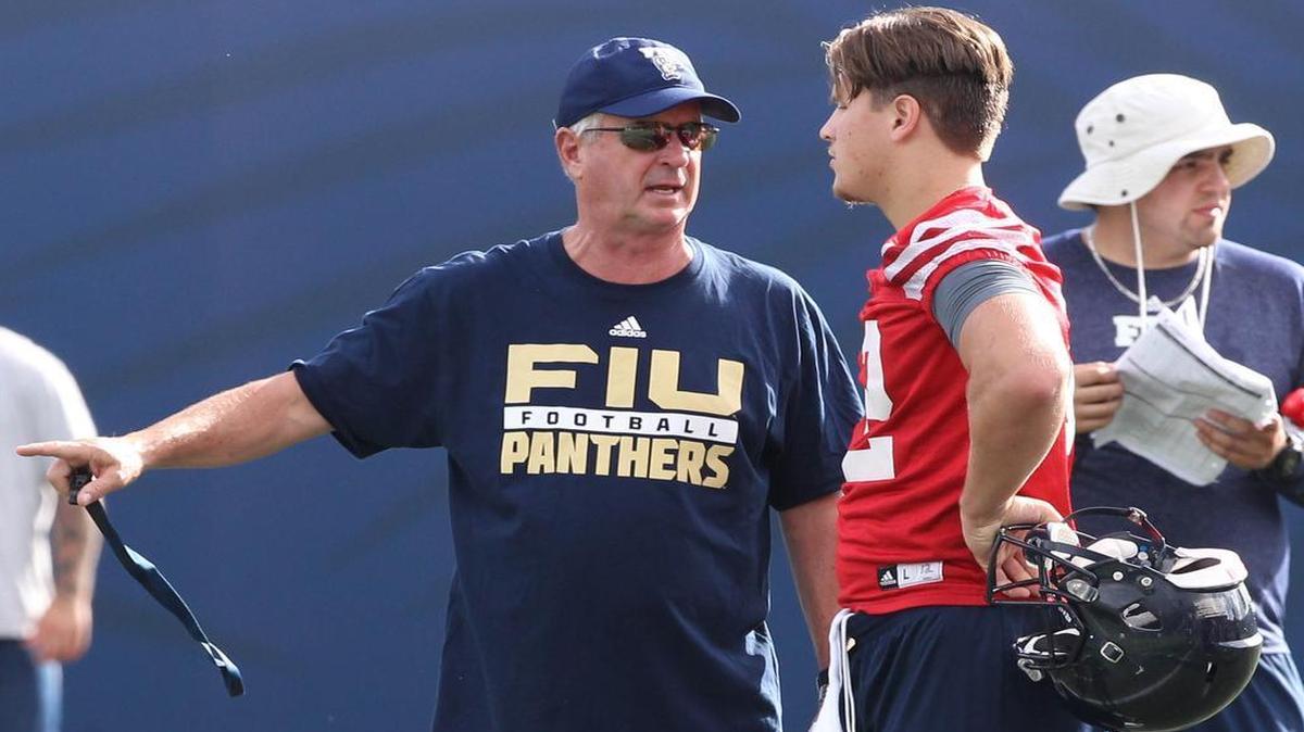 
FIU coach Ron Turner talks to quarterback Alex McGough during the first day of FIU training camp at FIU Stadium on Wednesday, Aug. 5, 2015.
