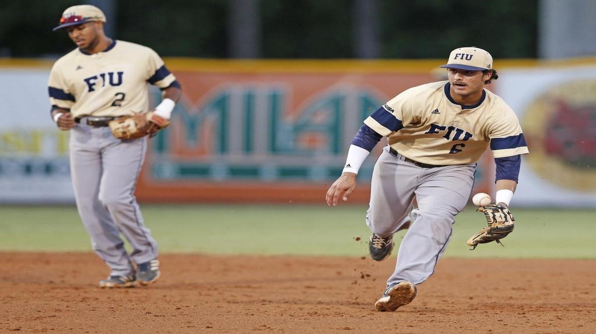 
FIU infielder Eddie Silva (6) chases the ball after FIU shortstop Julius Gaines (2) commits an infield error in the third inning as the University of Miami hosts Florida International University in the Coral Gables Regional of the NCAA tournament at Alex Rodriguez Park at Mark Light Field in Coral Gables on May 29, 2015
