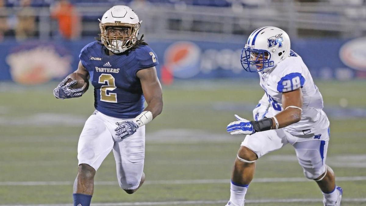 FIU running back Anthony Jones runs for a first down as Middle Tennessee’s Malik Hawkins pursues in the first half on Saturday, October 29, 2016.