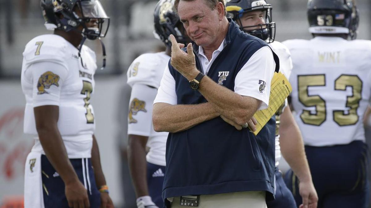 Florida International coach Butch Davis, center, watches his players warm up during their game against Central Florida on Aug. 31. FIU was humbled by shorthanded Middle Tennessee 37-17 at Red Floyd Stadium on Saturday.