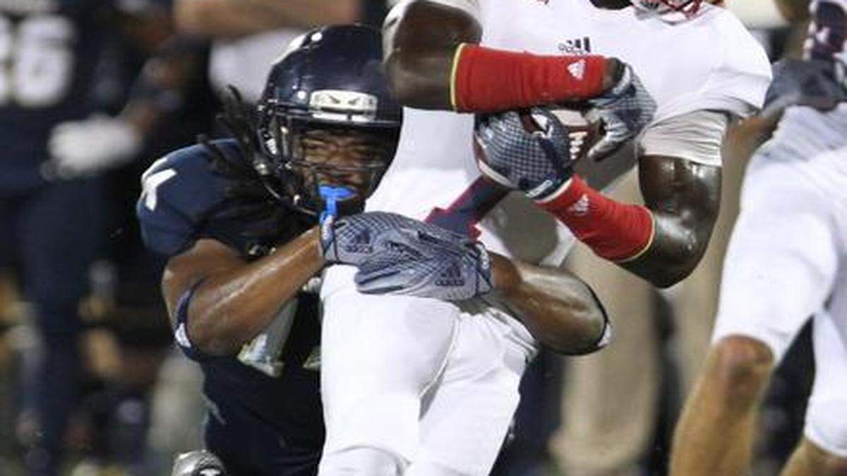 
Demarkus Perkins of FIU stops Lucky Whitehead of FAU after he gains a first down in the first quarter as the FIU Panthers play the FAU Owls on Ocean Bank Field at Florida International University Stadium in Miami.
