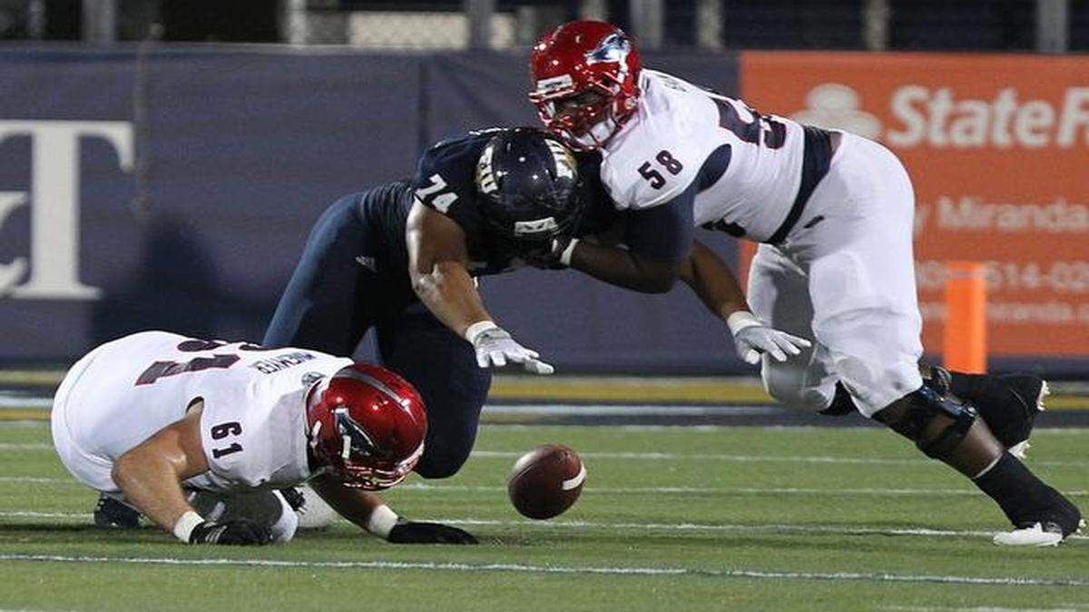 
Lars Koht of FIU recovers a fumble in the second quarter as the FIU Panthers play the FAU Owls on Ocean Bank Field at Florida International University Stadiumin in Miami, Thursday, Oct. 2, 2014.
