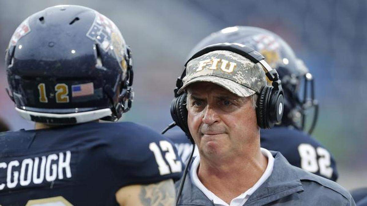 
Head coach Ron Turner talks to Alex McGough # 12 of the Florida International Panthers after he threw an interception against the Louisville Cardinals on September 20, 2014 at FIU Stadium in Miami, Florida.
