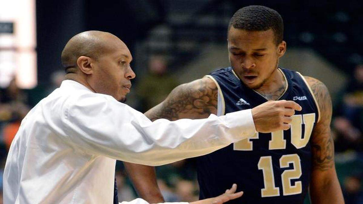 
 FIU coach Anthony Evans instructs Dominique Williams during a game at Alabama-Birmingham. 
