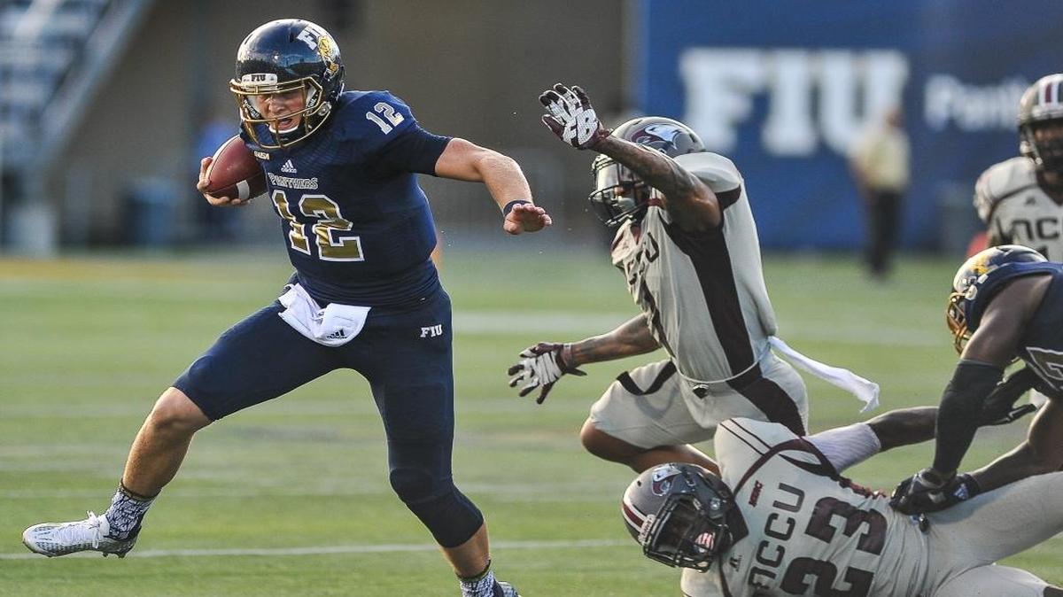 FIU Quarterback Alex McGough breaks a tackle during college football game, Saturday, Sept. 19, 2015 in Miami against the N.C. Central Eagles at the Ocean Bank Field at Florida International University.