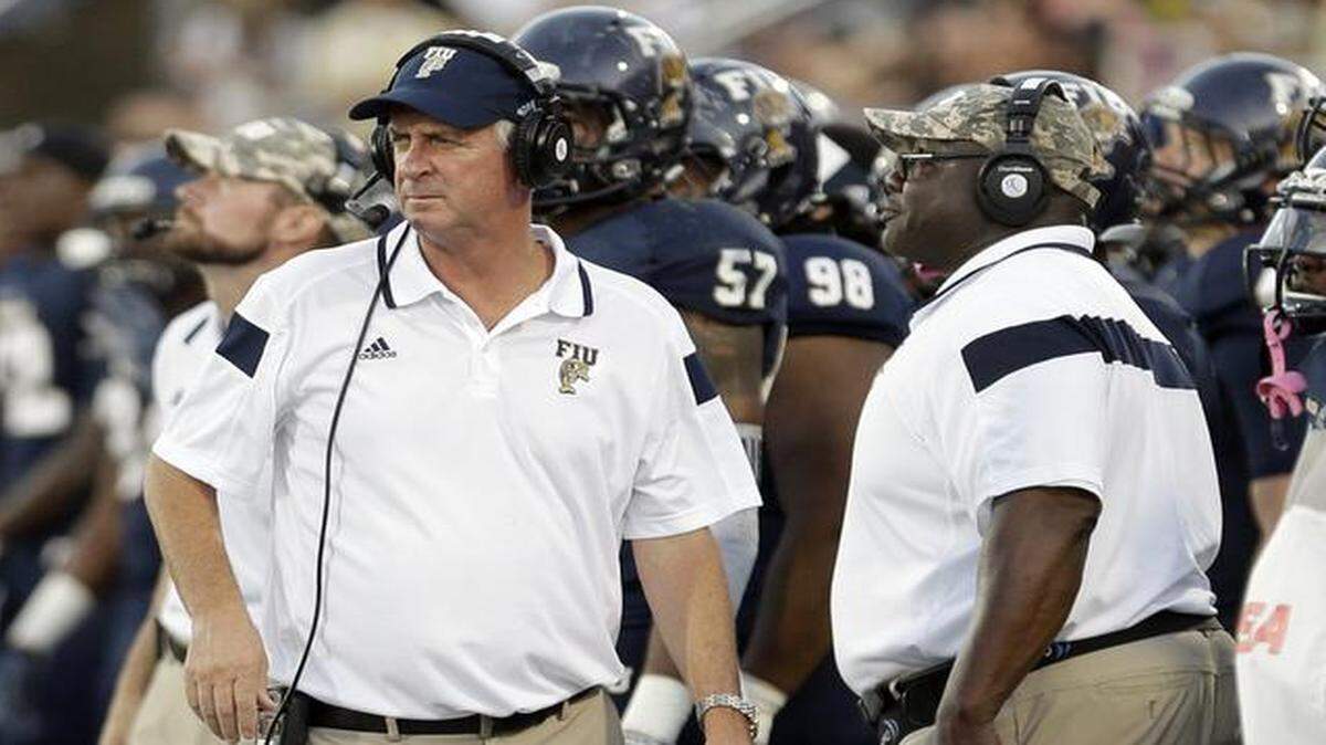 
FIU head coach Ron Turner, left, walks on the sideline during the first half of an NCAA college football game against Marshall , Saturday, Oct. 18, 2014, in Miami.
