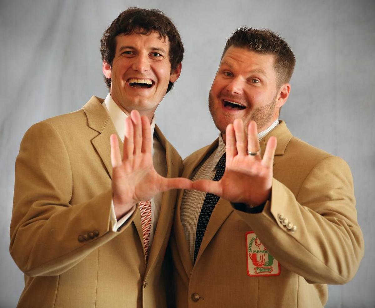Former quarterback Ken Dorsey, left, and center Brett Romberg flash the U at the University of Miami Sports Hall of Fame Induction Ceremony at Jungle Island on April 11, 2013.